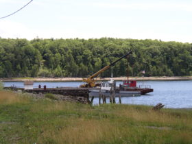Wharf and barge in the Penobscot River in Winterport (2003)