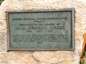 plaque: "Dedicated to the Memory of John Godfrey Moore, 1848-1899" (2004)