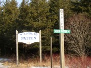 Sign: "Welcome to Patten," "Town Line, Patten, South Patten 