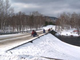 Snowmobilers crossing the East Branch of the Penobscot River in T6 R8 WELS (2006)