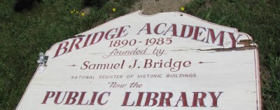 sign: "Bridge Academy, 1890-1985, founded by Samuel J. Bridge, National Register of Historic Buildings, Now the Public Library" (2010)