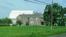 Farmhouse and Barn in a Field in Houlton on U.S. Route 2