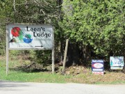 Sign: Leen's Lodge" and for sale signs on the Milford Road