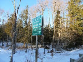 sign: "Town Line, Entering Orneville Twp from Bradford on the Lagrange Road , Piscataquis County Line" on Route 155