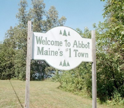 Sign: "Welcome to Abbot. Maine's #1 Town"