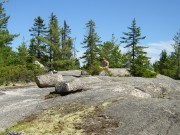 A hiker rests at the Rainbow Ledges