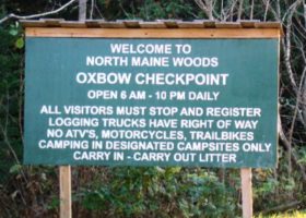 Sign: "Welcome to North Maine Woods, Oxbow Checkpoint . . . ."
